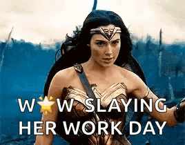 A Woman In A Wonder Woman Costume Is Holding A Sword And A Shield . GIF