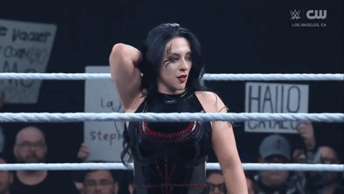 A Woman In A Wrestling Ring Has A Sign That Says Hallo On It GIF