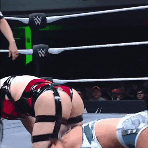 A Woman In A Wrestling Ring Has The Letter W On Her Back GIF