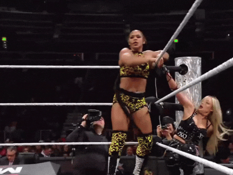 A Woman In A Wrestling Ring Holds A Rope That Says Xo On It GIF