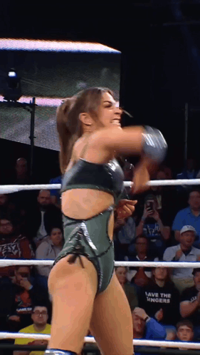 a woman in a wrestling ring is wearing a black shirt that says save the sinners