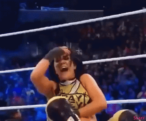 A Woman In A Wrestling Ring Wearing A Shirt That Says Payback On It GIF