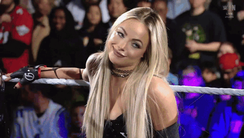 A Woman In A Wrestling Ring With A Glove That Says G On It GIF