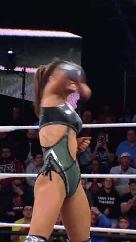 a woman in a wrestling ring with a shirt that says save the numbers