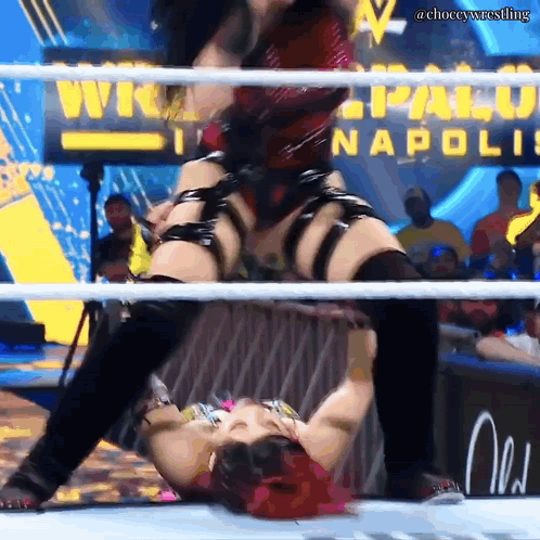 A Woman In A Wrestling Ring With A Sign That Says Napoli GIF