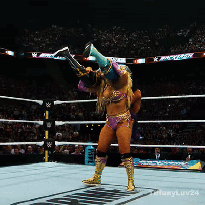 A Woman In A Wrestling Ring With A Sign That Says Prince In The Background GIF