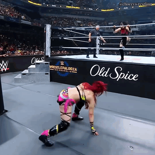 A Woman In A Wrestling Ring With An Old Spice Sign In The Background GIF