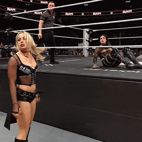 A Woman In A Wrestling Ring With Raw Written On The Walls GIF