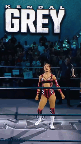 a woman in a wrestling ring with the name kendal grey