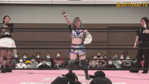 a woman in a wrestling ring with the number 18 on her sleeve