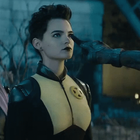 A Woman In A X-Men Costume Is Being Touched By A Man 'S Hand GIF