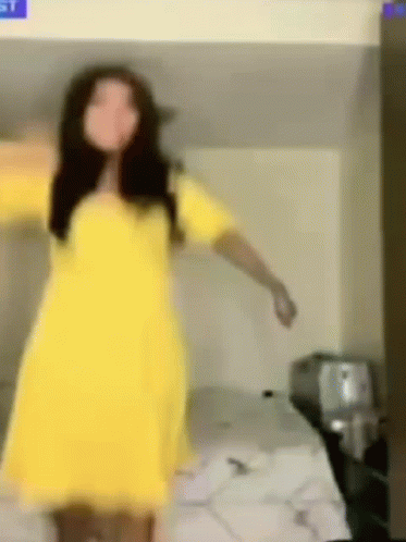 A Woman In A Yellow Dress Is Dancing On A Bunk Bed . GIF