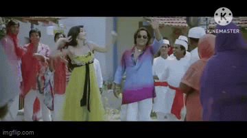 A Woman In A Yellow Dress Is Dancing With A Man In A Blue Shirt In Front Of A Crowd Of People . GIF