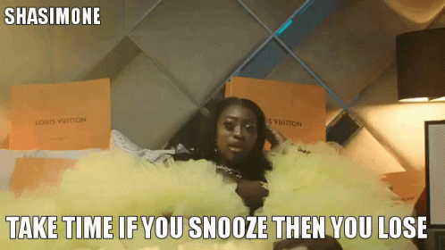 A Woman In A Yellow Dress Is Laying On A Bed With Louis Vuitton Boxes Behind Her GIF
