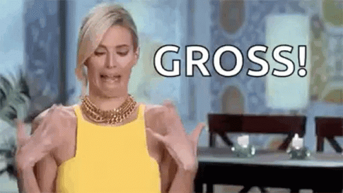 A Woman In A Yellow Dress Is Making A Funny Face While Holding Her Hands Up And Saying Gross . GIF