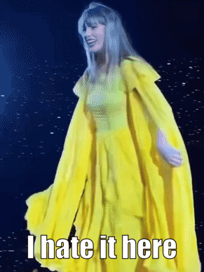 A Woman In A Yellow Dress With The Words " I Hate It Here " On The Bottom GIF