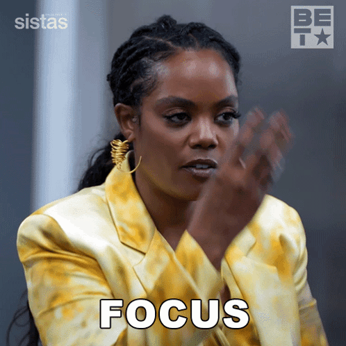 A Woman In A Yellow Jacket Has The Word Focus Written On Her Face GIF