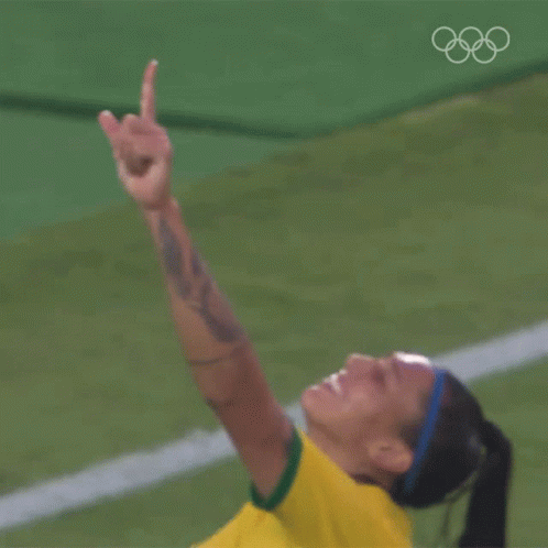 a woman in a yellow shirt is giving a thumbs up sign