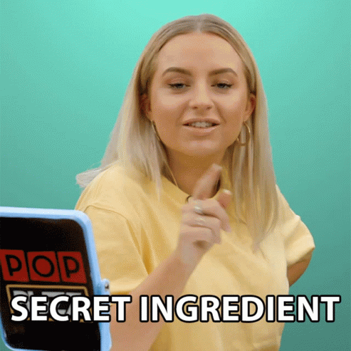 A Woman In A Yellow Shirt Is Pointing At A Screen That Says Pop Secret Ingredient GIF