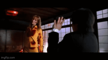 A Woman In A Yellow Shirt Is Saying Go Home To Your Mother . GIF