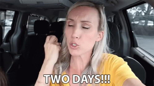 A Woman In A Yellow Shirt Is Sitting In A Car And Says Two Days !!! GIF