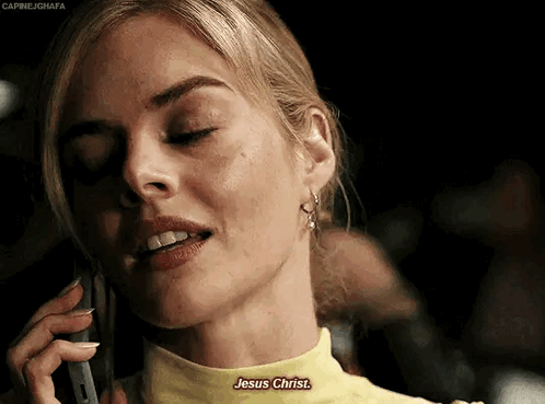 A Woman In A Yellow Shirt Is Talking On A Cell Phone And Says Jesus Christ . GIF