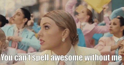 A Woman In A Yellow Suit And Tie Says " You Can 'T Spell Awesome Without Me " In Front Of A Crowd Of People GIF