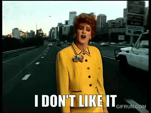 A Woman In A Yellow Suit Stands On A Highway And Says I Don 'T Like It GIF