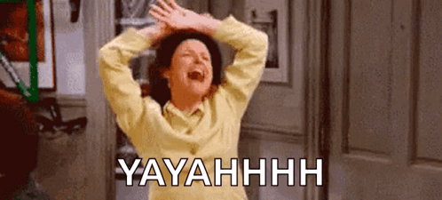 A Woman In A Yellow Sweater Is Laughing With Her Hands In The Air And The Words Yayahhh Written Below Her . GIF