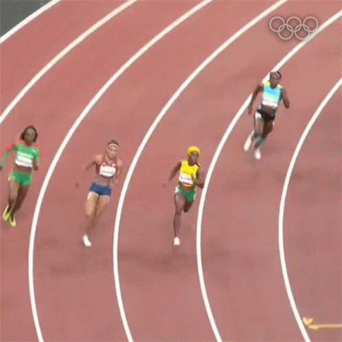 A Woman In A Yellow Top And Green Shorts With The Number 6 On Her Shorts Is Running On A Track . GIF