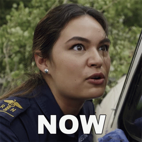A Woman In An Ambulance Uniform Has The Word Now Written On Her Face GIF