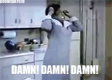 A Woman In An Apron Is Standing In A Kitchen With The Words `` Damn ! Damn ! Damn ! '' . GIF