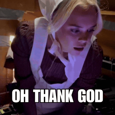 A Woman In An Apron With The Words Oh Thank God Written Below Her GIF