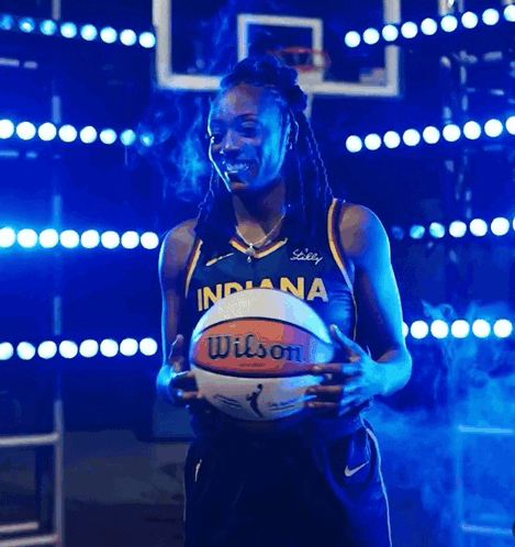 A Woman In An Indiana Jersey Holds A Basketball In Her Hands GIF