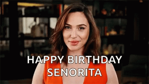 A Woman In An Orange Dress Says Happy Birthday Senorita GIF