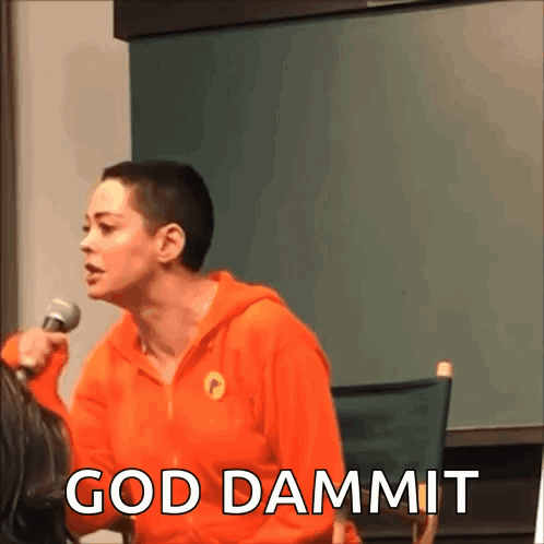 A Woman In An Orange Hoodie Is Holding A Microphone And The Words God Dammit Are Above Her GIF