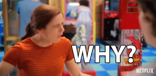 A Woman In An Orange Striped Shirt Is Asking Why In An Arcade . GIF