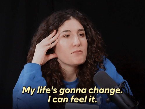 A Woman In Front Of A Microphone Says " My Life 'S Gonna Change .. I Can Feel It " GIF