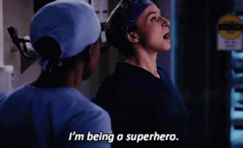 A Woman In Scrubs Says I 'M Being A Superhero Next To A Man In Scrubs GIF