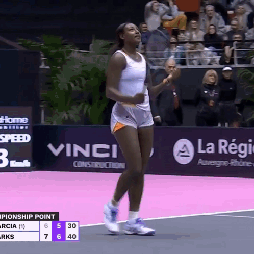 A Woman In Shorts Is Walking On A Tennis Court GIF