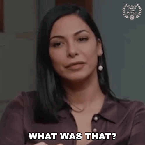 A Woman Is Asking What Was That While Holding Her Hand To Her Chest . GIF