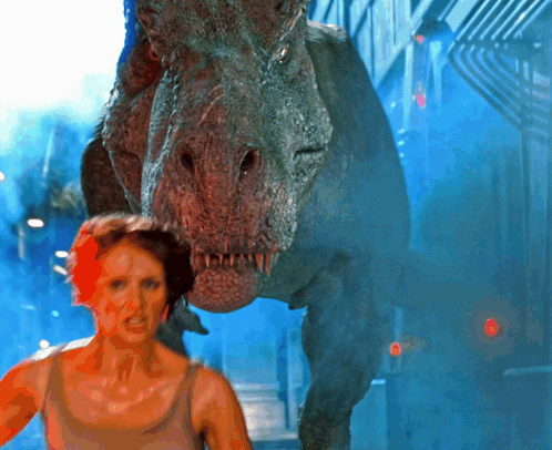 A Woman Is Being Attacked By A Dinosaur In A Scene From A Movie GIF