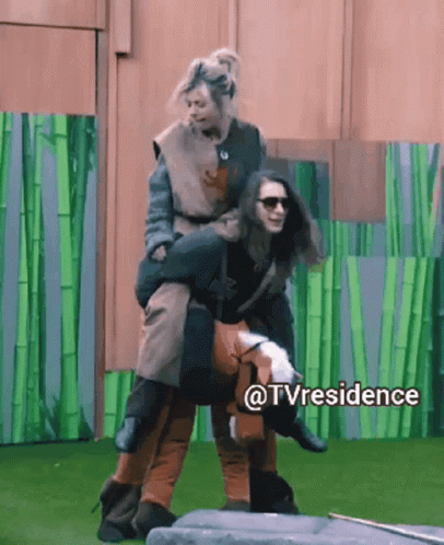 A Woman Is Being Carried On The Back Of Another Woman In A Tv Residence Scene GIF