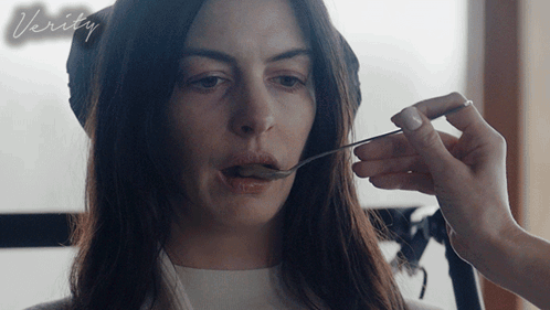 A Woman Is Being Fed With A Spoon And The Word Verity Is On The Bottom Right GIF
