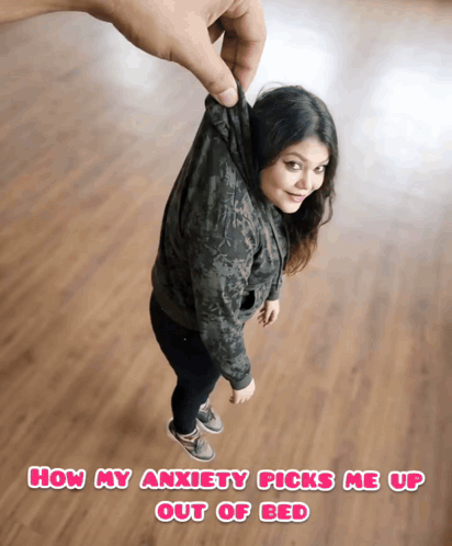 A Woman Is Being Held Up By A Hand With The Caption How My Anxiety Picks Me Up Out Of Bed Below Her GIF