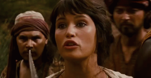 A Woman Is Being Tied Up By A Man With A Rope Around Her Mouth . GIF