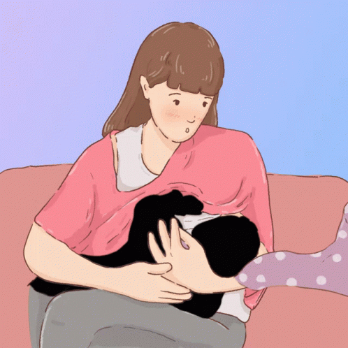 A Woman Is Breastfeeding A Baby On A Couch GIF