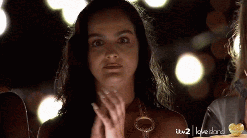 A Woman Is Clapping In A Love Island Ad GIF