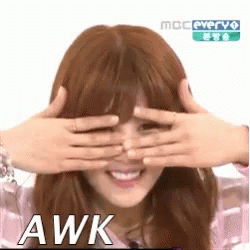 A Woman Is Covering Her Eyes With Her Hands And The Word Awk Is On The Bottom . GIF