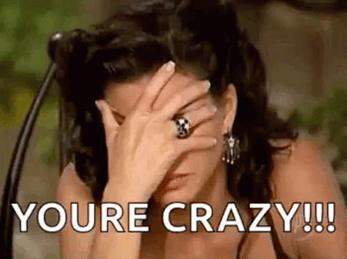 A Woman Is Covering Her Face With Her Hand And The Words `` You 'Re Crazy ! '' GIF